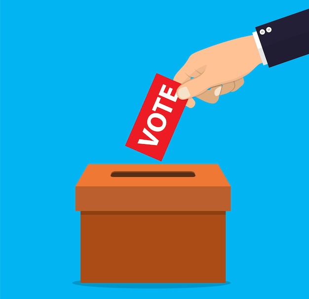 Mano umana che mette la carta di voto