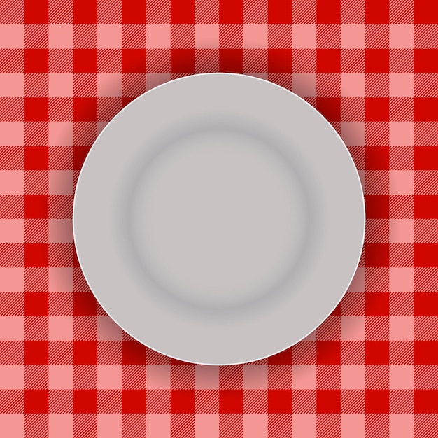 Piatto vuoto su tovaglia rossa di Gingham