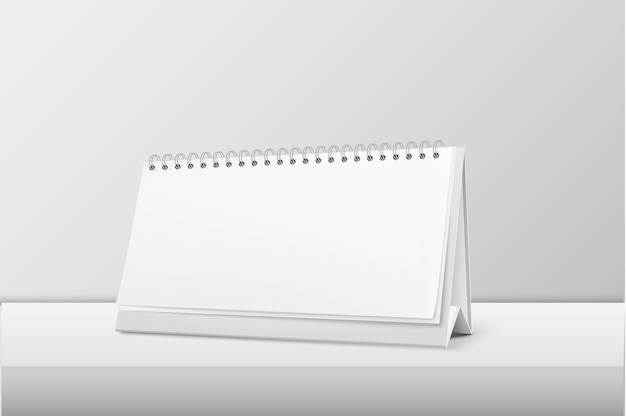 primo piano a spirale in bianco orizzontale realistico del calendario che sta sulla tavola bianca. Modello di progettazione