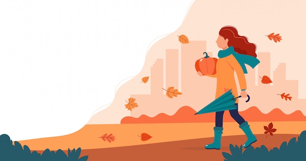 Ragazza con una zucca in autunno.