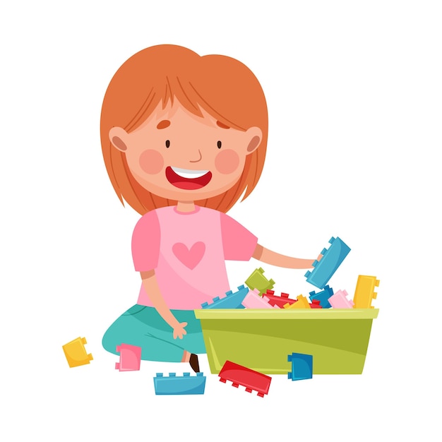 Ragazza felice seduta sul pavimento nella sala giochi e giocando con l'illustrazione vettoriale del giocattolo di costruzione