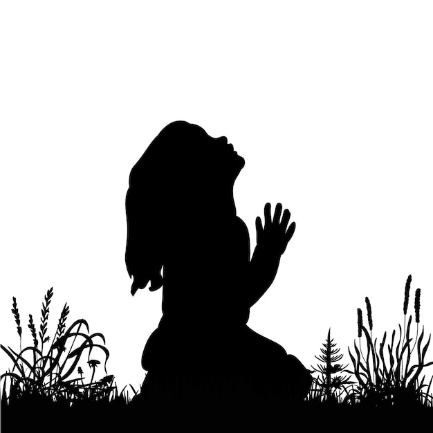 Silhouette bambina che prega sull'erba