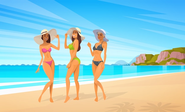 Tre donne in bikini sulla spiaggia