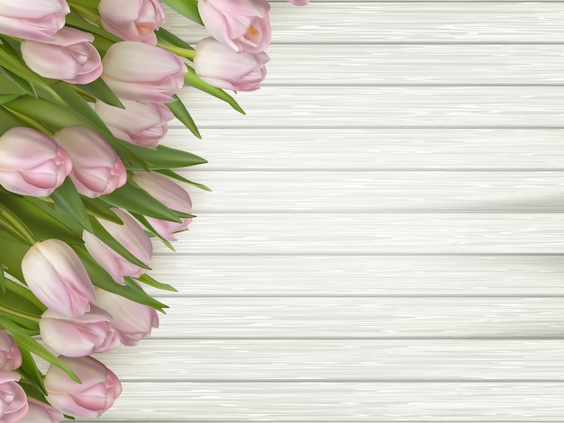 Tulipani rosa dei fiori sul di legno leggero.