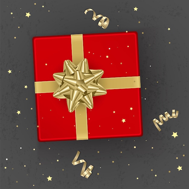 Una confezione regalo rossa realistica decorata con un fiocco dorato, vista dall'alto.
