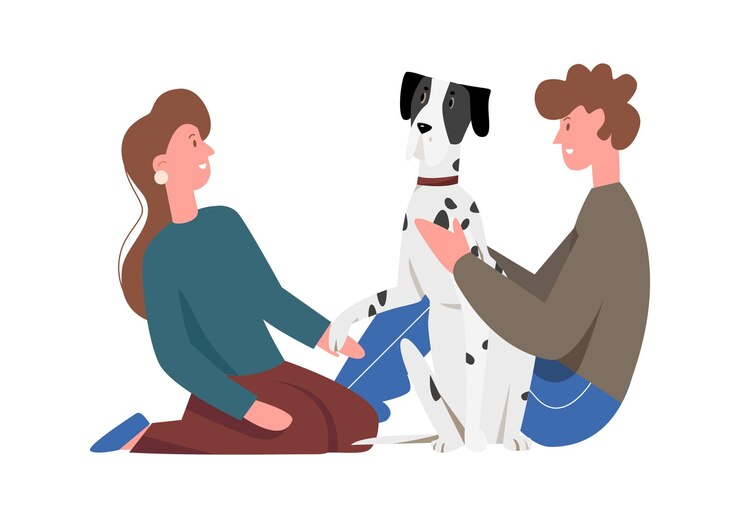 Una coppia seduta con un cane felice sul pavimento con una ragazza che tiene la zampa di un cucciolo