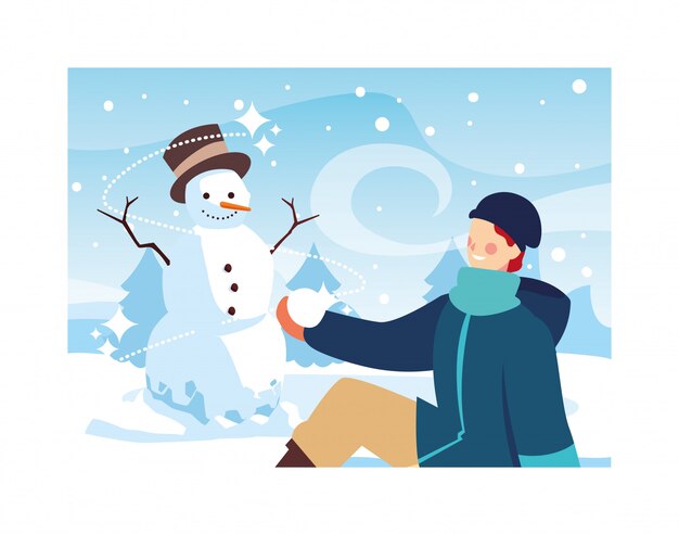 Uomo con pupazzo di neve nel paesaggio invernale