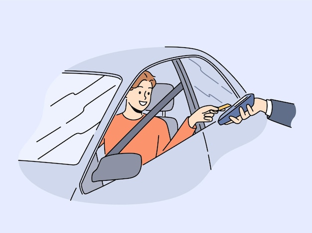 Uomo sorridente in auto paga con la carta sul terminale