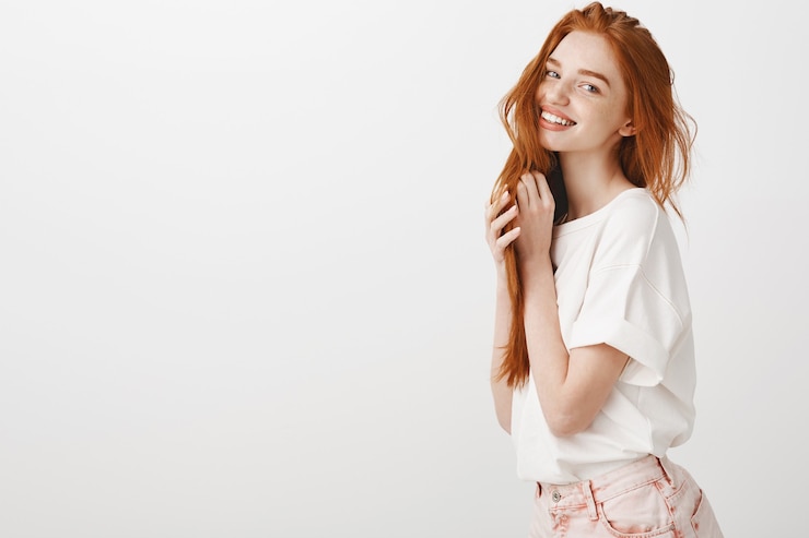 Gratis Foto aanbiddelijke roodharige vrouw die teder en glimlachend kijkt