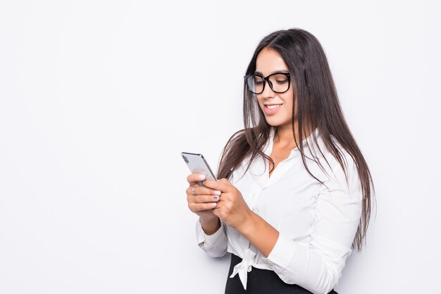 Aantrekkelijke zakenvrouw met behulp van slimme telefoon geïsoleerd op wit