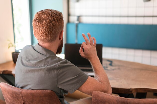 Achteraanzicht knappe moderne man aan het werk