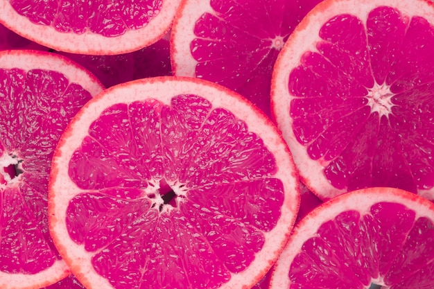 Gratis foto achtergrond van sappige grapefruits plakjes