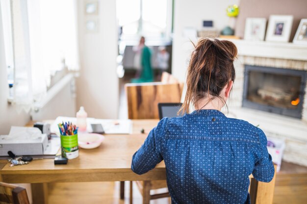 Achtermening van een vrouwenzitting in woonkamer