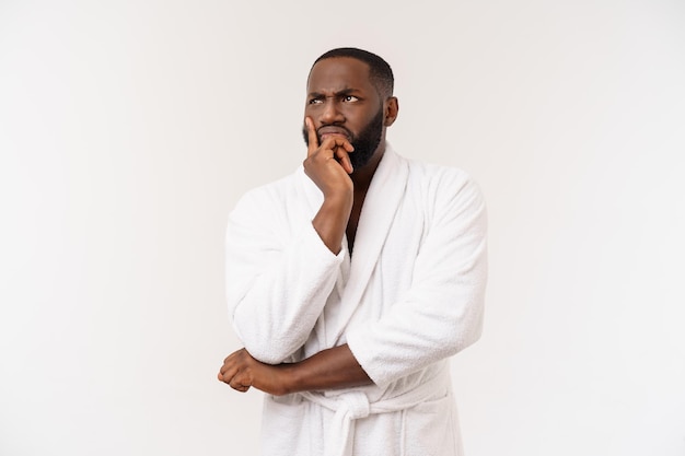 Afro-Amerikaanse man draagt een badjas met verrassing en blije emotie geïsoleerd over witte achtergrond