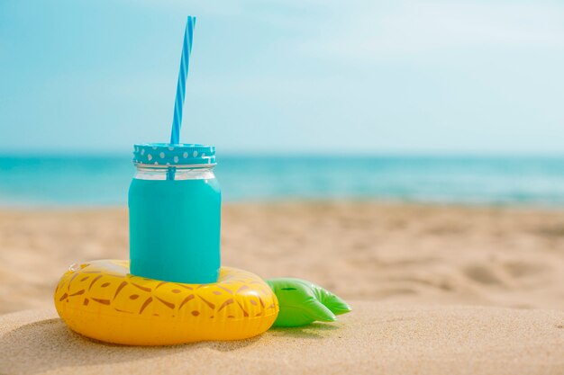 Ananassap met een opblaasboot op het strand