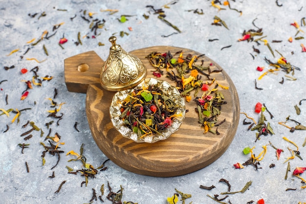 Assortiment van droge thee in gouden vintage mini bordjes. Thee soorten