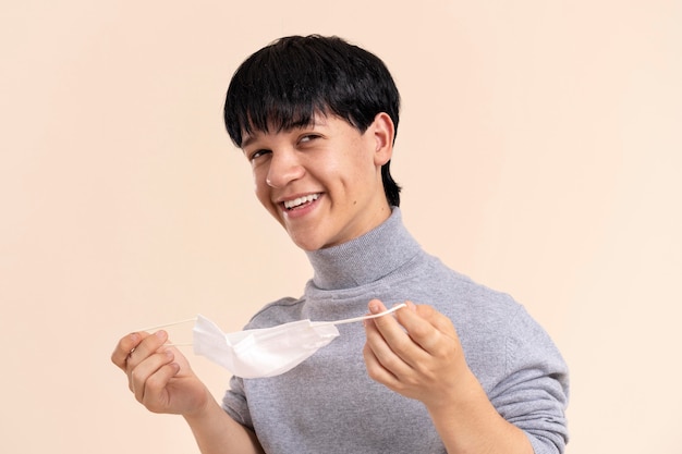 Gratis foto aziatische man met dwerggroei met een medisch masker