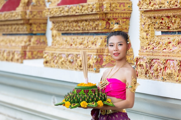 Azië vrouw in Thaise jurk traditionele greep kratong. Loy krathong-festival