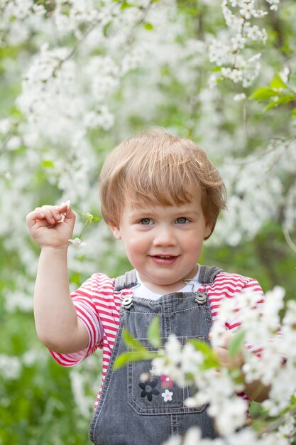 Baby meisje in bloeiende tuin