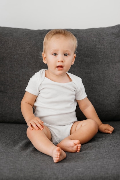 Babyjongen zittend op de bank te wachten om te eten