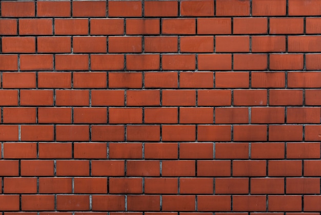 Bakstenen muur oranje behangpatroon