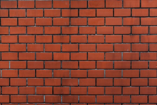 Bakstenen muur oranje behangpatroon