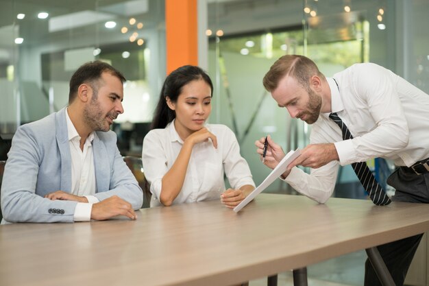 Bedrijfsmens die idee voorstellen aan zijn medewerkers in bureau