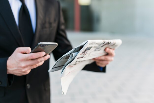 Bedrijfsmens die zijn mobiele telefoon met behulp van