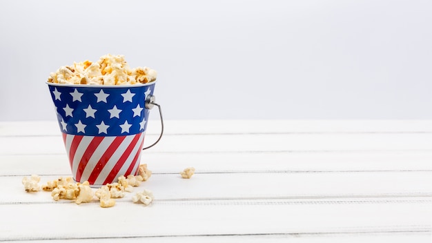 Gratis foto beker met amerikaanse vlag en popcorn op witte ondergrond