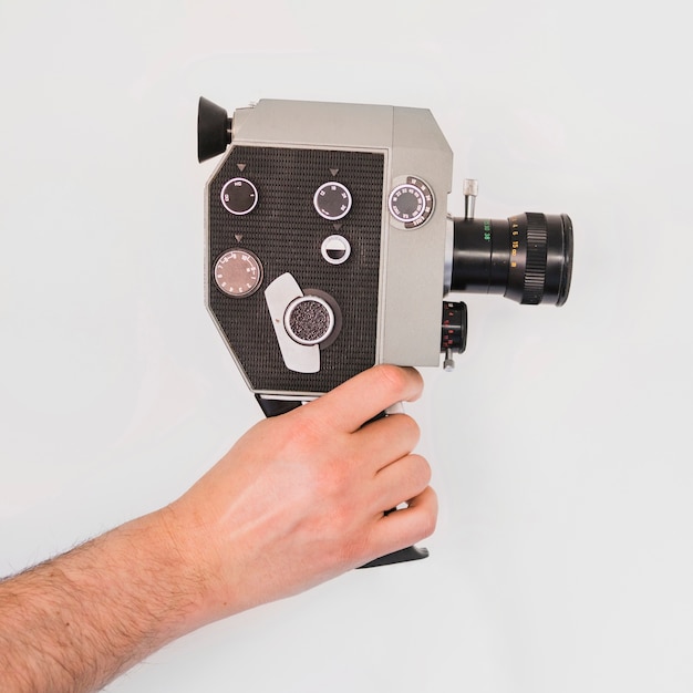 Gratis foto bereik cameraman met vintage gadget