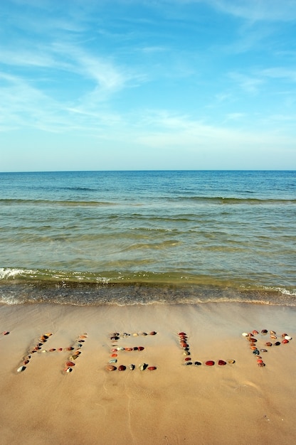 Gratis foto bericht in het zand