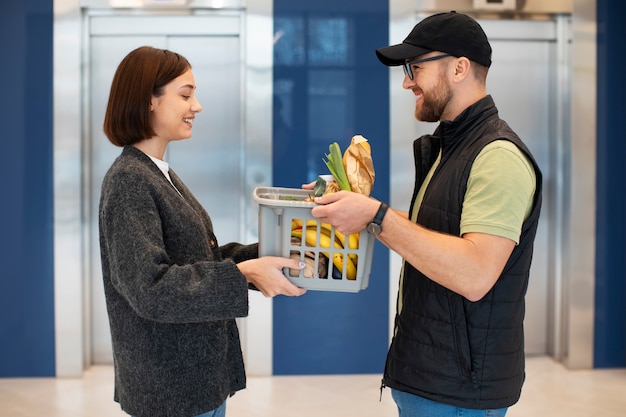 Bezorger die boodschappen geeft aan de klant