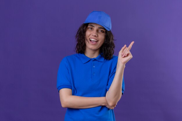 Bezorgmeisje in blauw uniform en pet herinnert zich dat ze het belangrijke niet vergeet te glimlachen terwijl ze op afgelegen paars staat