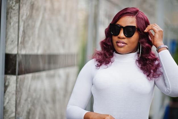 Big mama plus size Afro-Amerikaanse model in zwarte zonnebril en leren rok buiten geposeerd