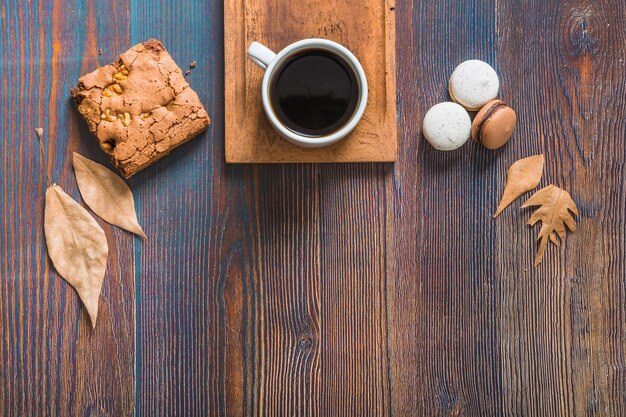 Bladeren en gebakje dichtbij koffie