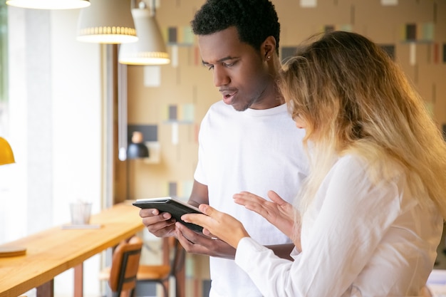 Blanke vrouw en African American scherm kijken