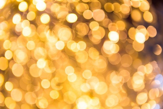 Gratis foto bokeh onscherpe gouden abstracte achtergrond van kerstmis