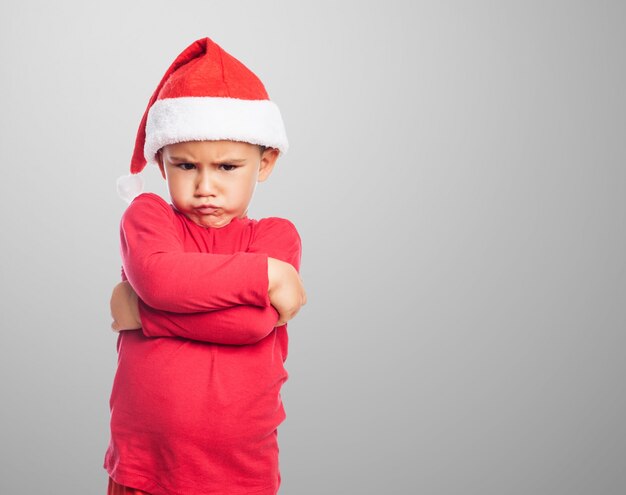 Boos kleine jongen met Kerst man hoed