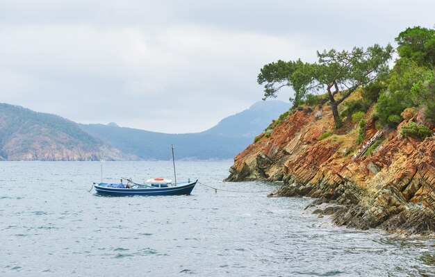 Boten die in een kalm blauw zeewater in de buurt van bergen in Turkije varen.