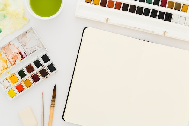 Bovenaanzicht aquarellen met penselen op tafel
