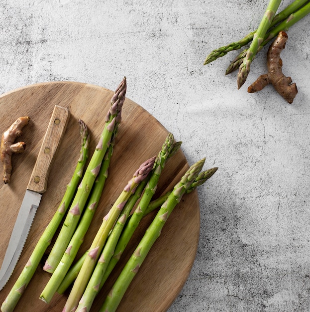 Gratis foto bovenaanzicht asperges op snijplank