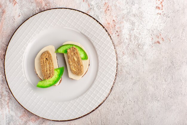 Bovenaanzicht brood toast met paté en komkommer plakjes binnen plaat op witte muur vlees groente eten maaltijd toast sandwich