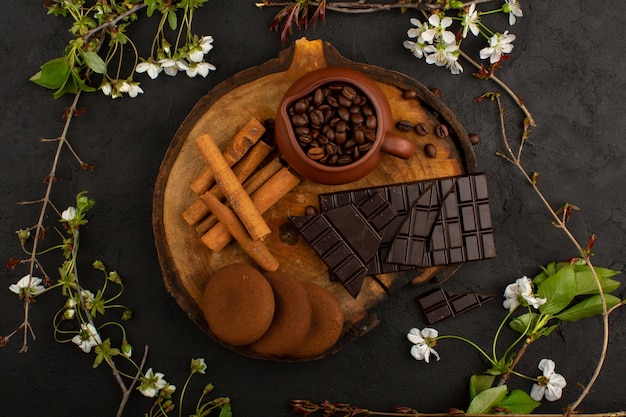 bovenaanzicht chocolade kaneel koffie op het bruine houten bureau en donker