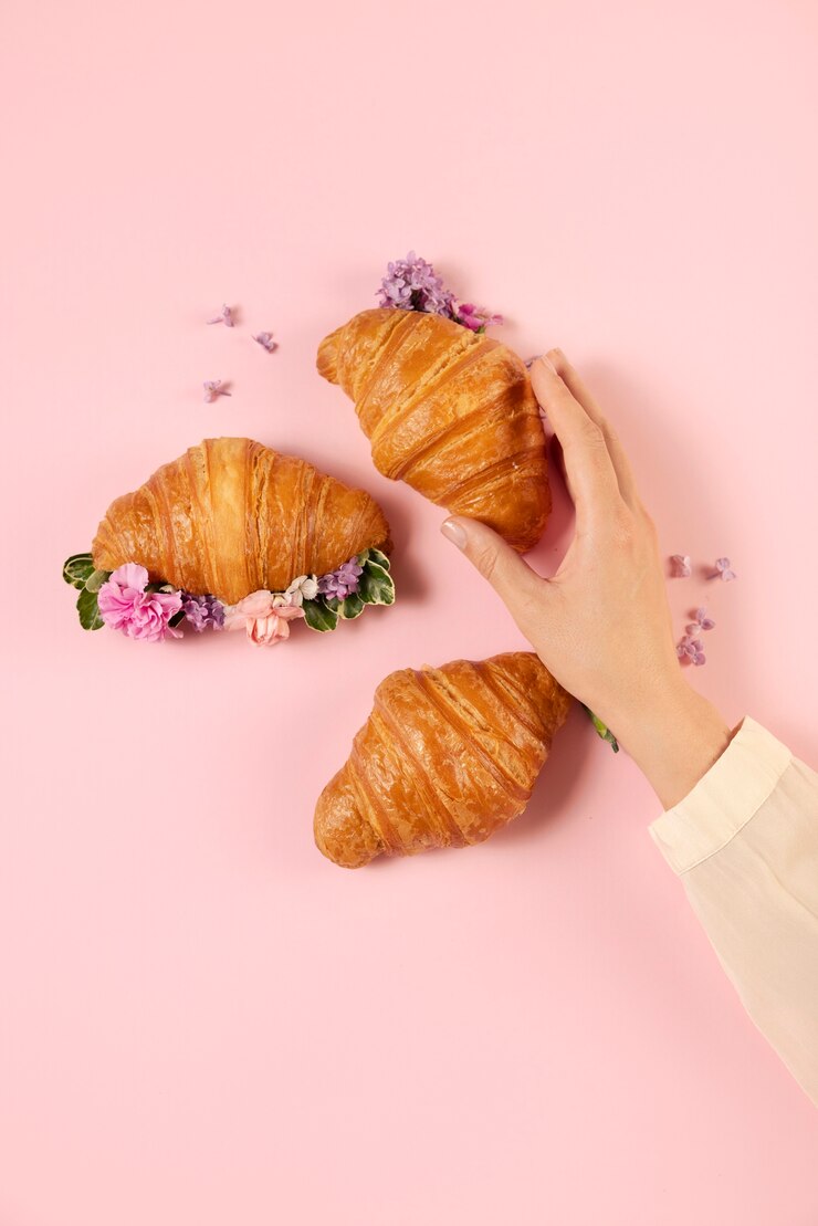 Gratis Foto bovenaanzicht croissants en bloemen arrangement