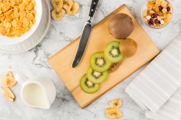 Bovenaanzicht gesneden kiwi met yoghurt en cornflakes