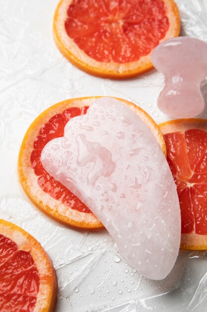 Bovenaanzicht gua sha en grapefruit arrangement