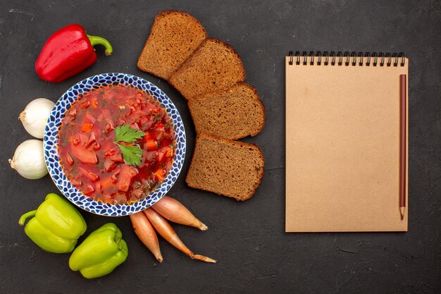 Bovenaanzicht heerlijke borsch met verse groenten en broodbroden op de donkere ruimte dark