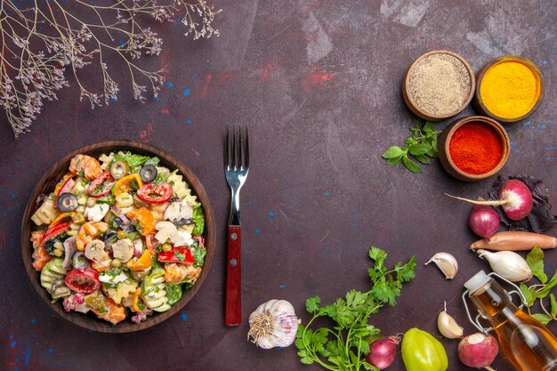 Bovenaanzicht heerlijke groentesalade met verschillende smaakmakers op een donkere achtergrond, gezonde groentedieet lunchsalade