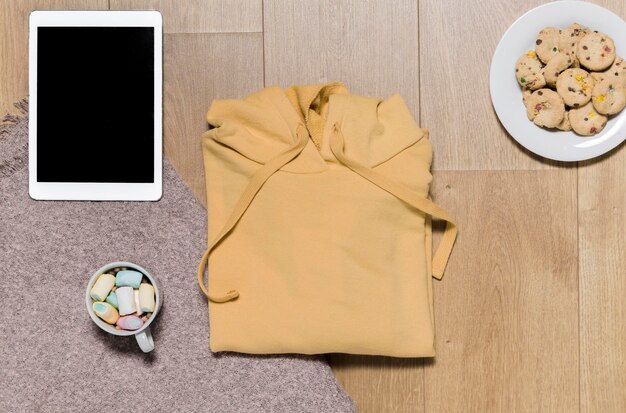 Bovenaanzicht hoodie met tablet naast