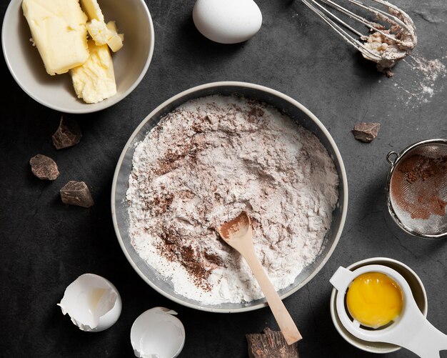 Bovenaanzicht kom met bloem en cacao op de tafel